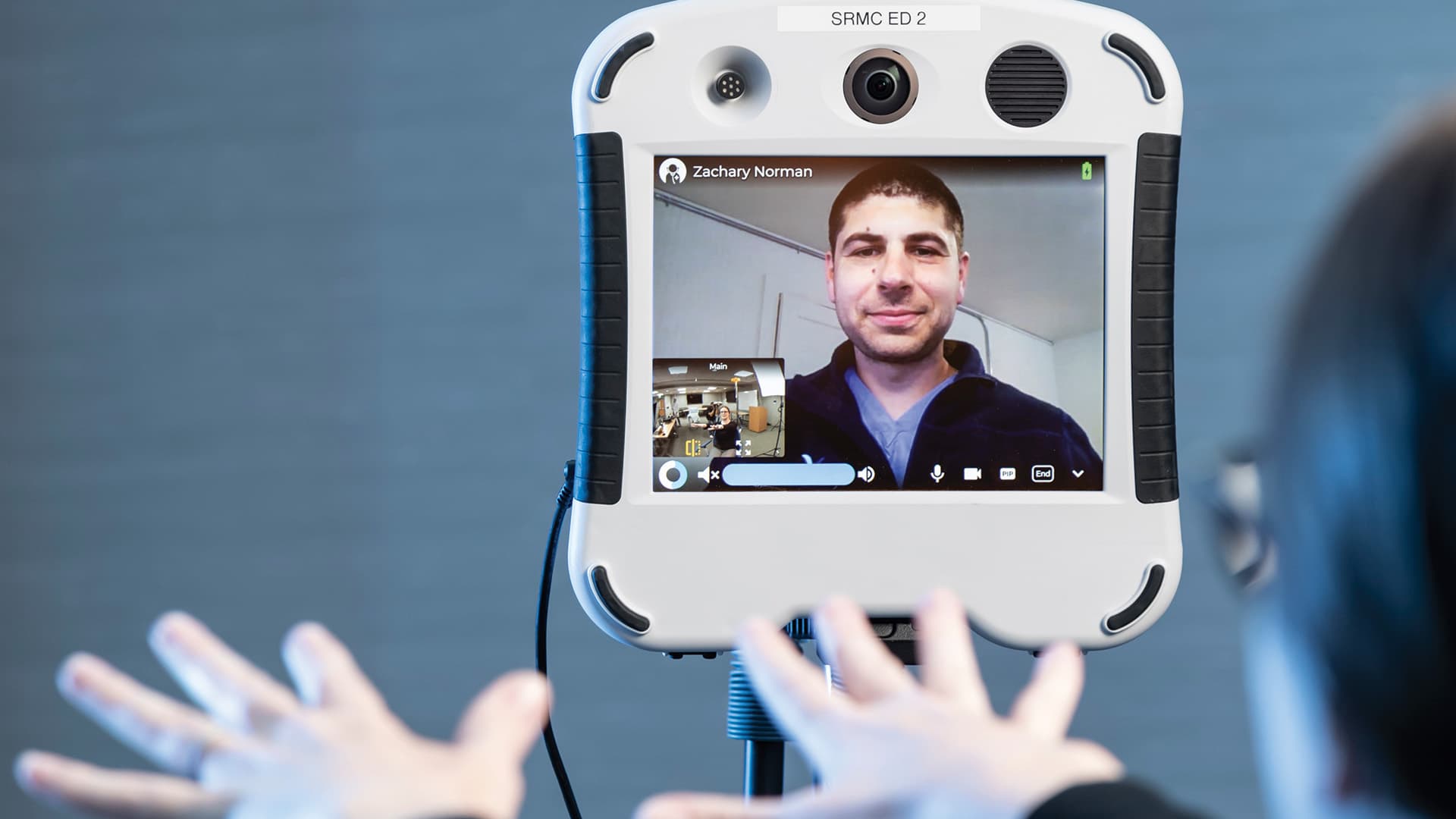 Blue Sky Telehealth doctor Zachary Norman on a video screen giving instructions to a patient