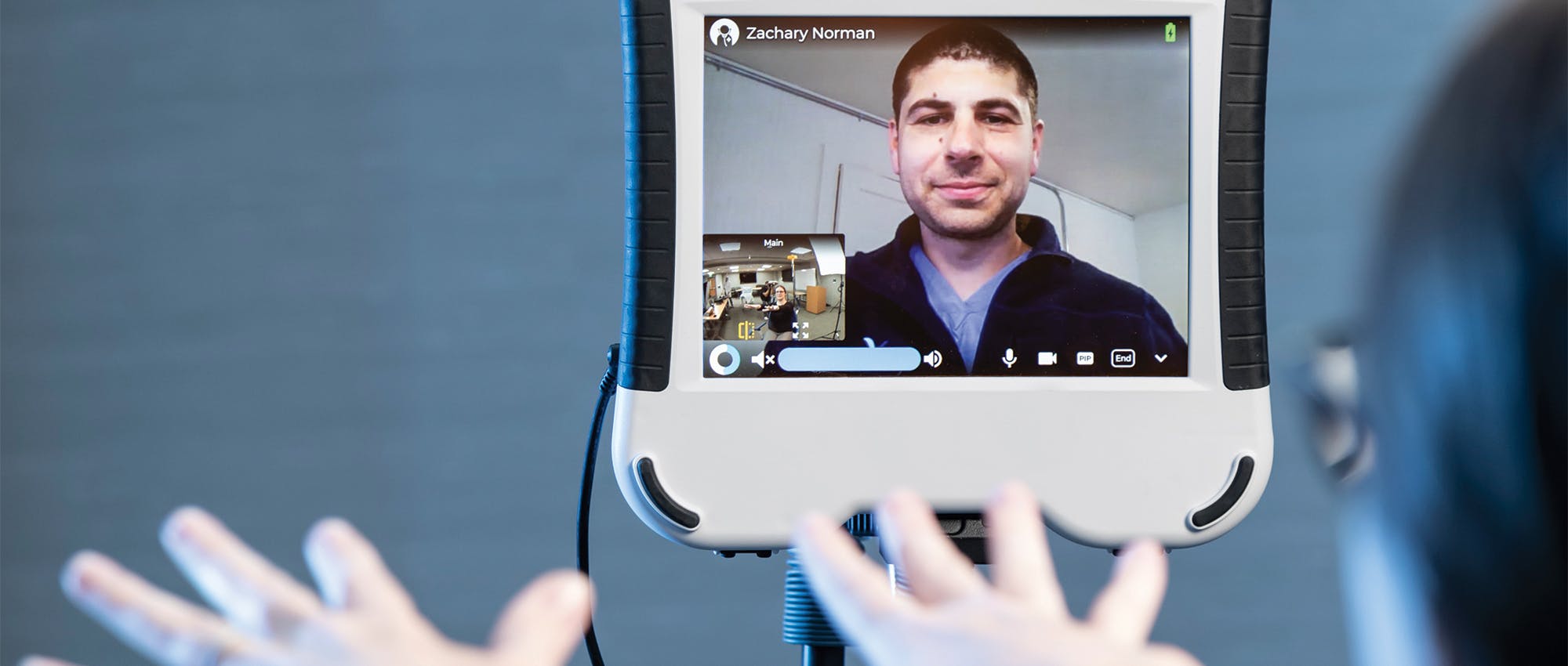 Blue Sky Telehealth doctor Zachary Norman on a video screen giving instructions to a patient
