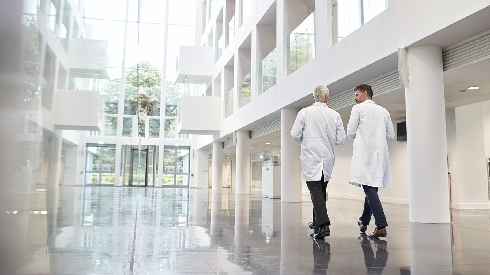 Two men walking in a hospital