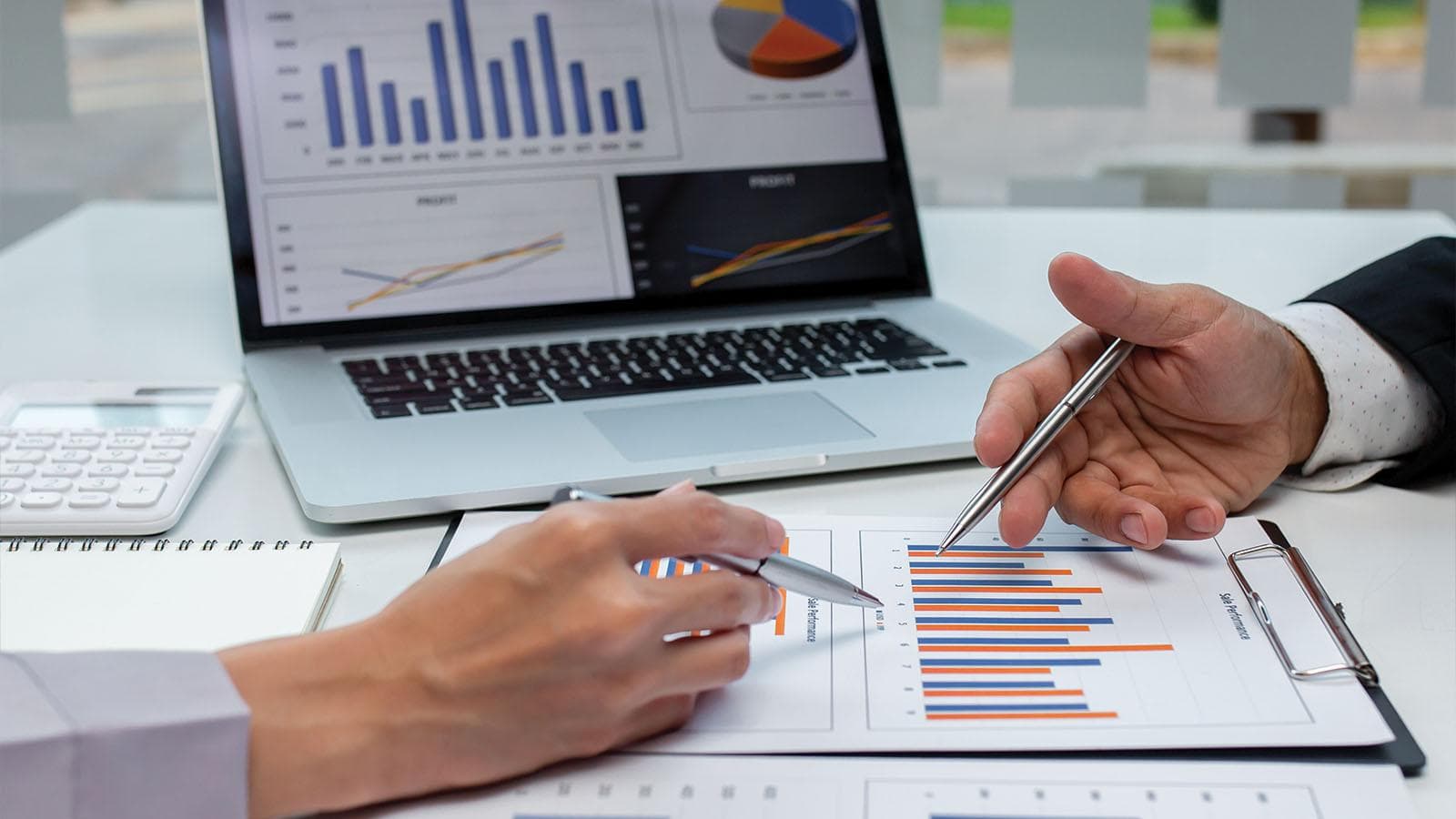 Two men analyzing charts